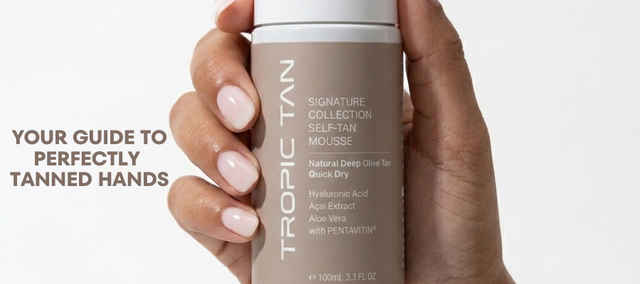 Hand holding a Tropic Tan bottle with text about tanned hands on a white background